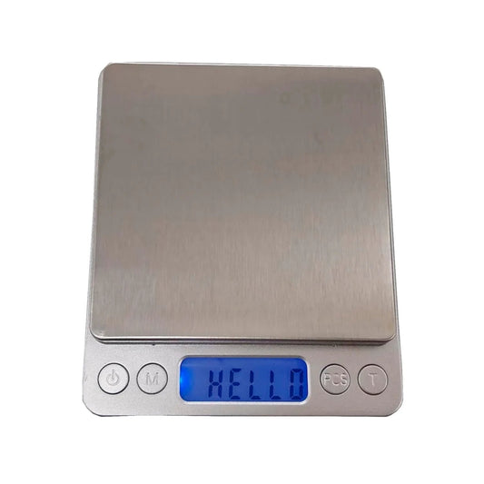 Báscula digital mini de precisión 3kg, plateada, plataforma de acero inoxidable, pantalla LCD azul.