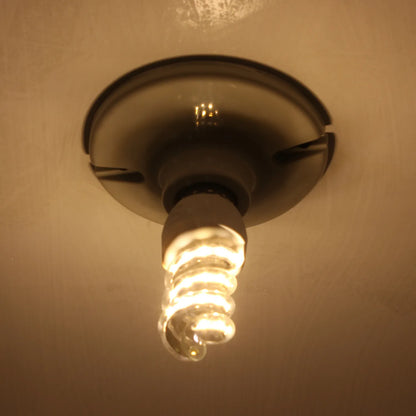 Ampolleta fluorescente espiral luz cálida encendida en base de techo blanca para iluminación de interiores